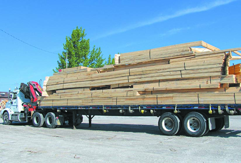 Crane truck loaded with trusses